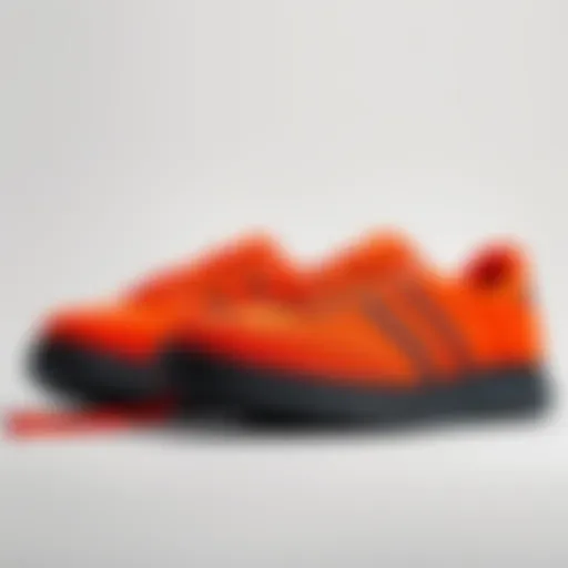 Vibrant Predator Orange lace-up shoes with a black outsole and white stitching displayed on a neutral background.
