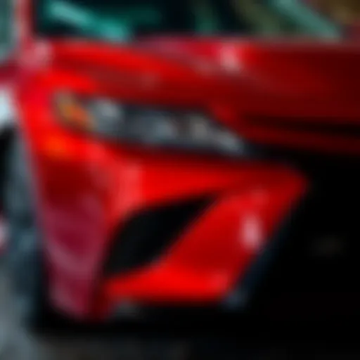 Close-up view of a damaged Toyota Camry XSE after hitting debris on the road