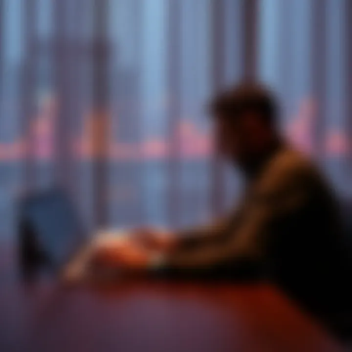 Man looking at a Bitcoin chart A man sits alone at a table, staring at his laptop displaying a Bitcoin trading chart, reflecting sadness and regret over lost love.